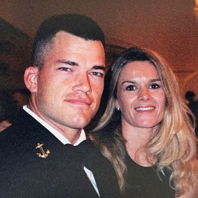 Jocko Willink is on a tuxedo with Navy badge and Hellen is wearing a black dress.